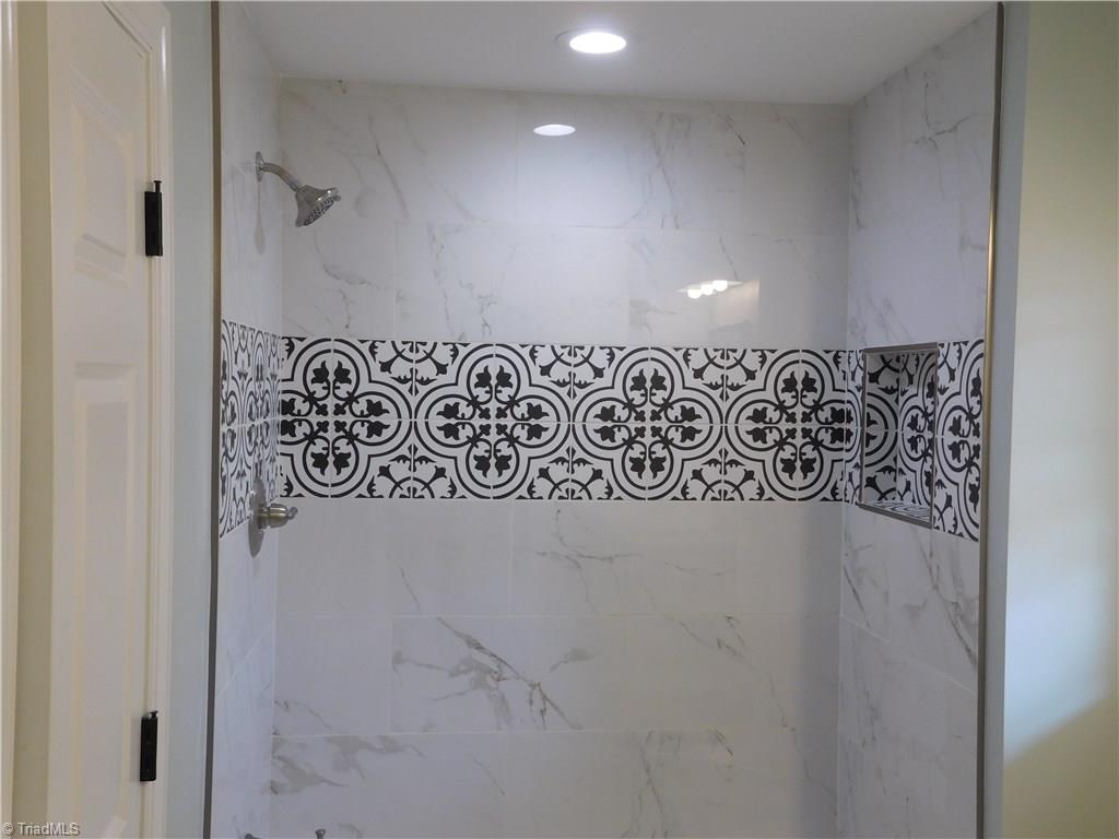 261 Jones Road Winston-Salem, NC 27107 - Photo 18 of 28 Beautiful and Efficient Master Bathroom. Tiled Surround for Tub/Shower & matching tile floor.