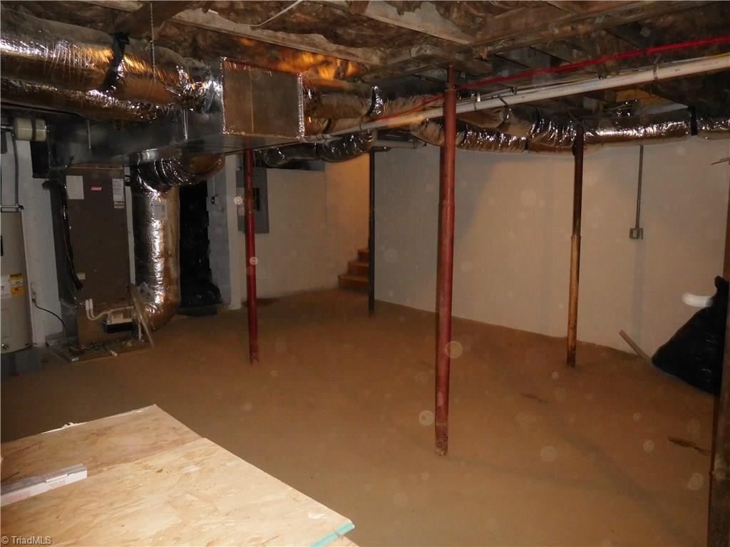 261 Jones Road Winston-Salem, NC 27107 - Photo 22 of 28 Unfinished partial basement with tall ceilings. Great for storage or endless possibilities.