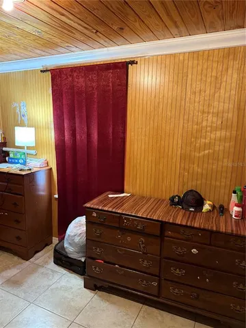 a room with a bed and a dresser