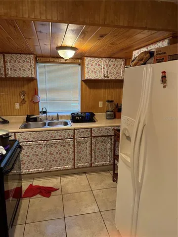 a kitchen with stainless steel appliances granite countertop a sink and a refrigerator