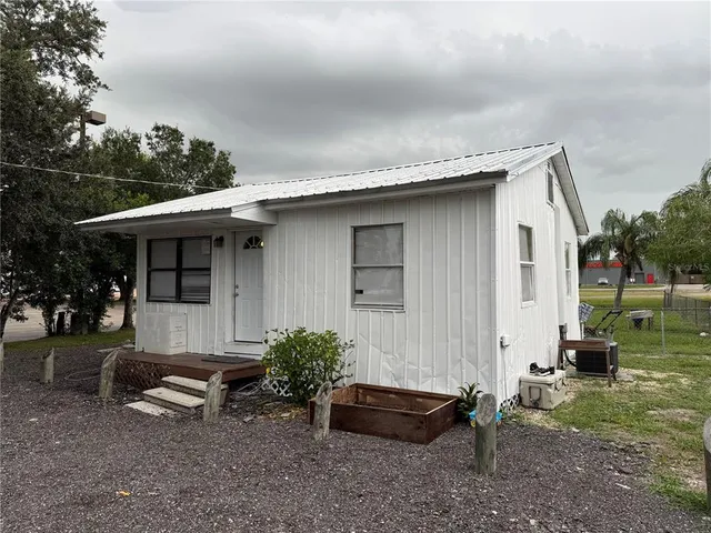 a backyard of a house with outdoor seating