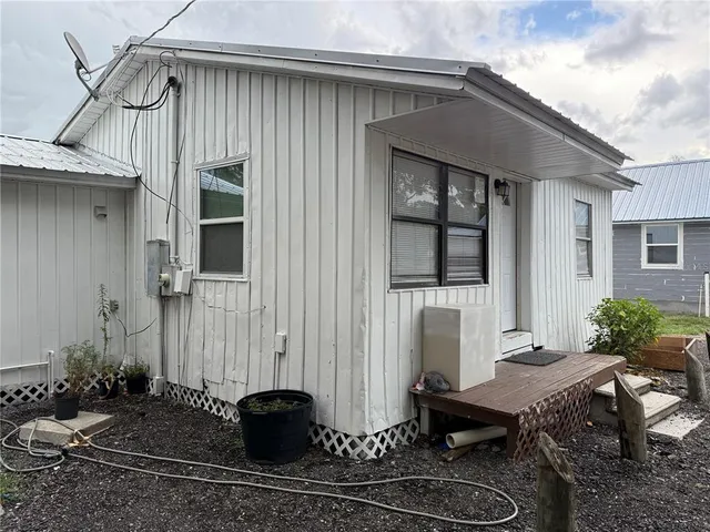 a backyard of a house with yard and outdoor seating