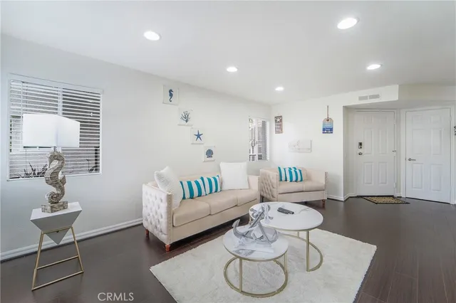 a living room with furniture and a lamp