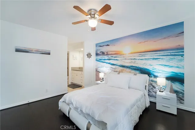 a bedroom with a bed and a ceiling fan