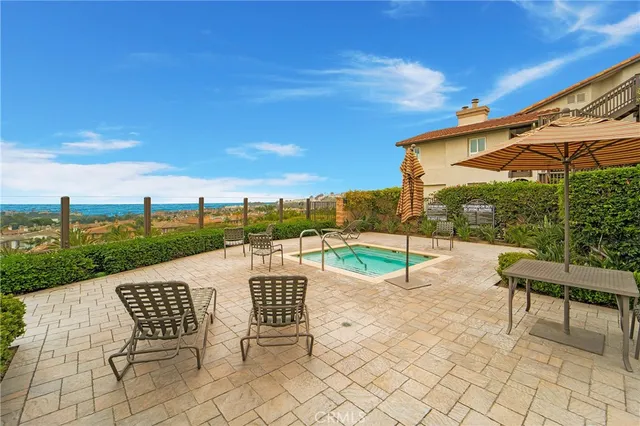 a view of a patio with a table chairs and a floor to ceiling window