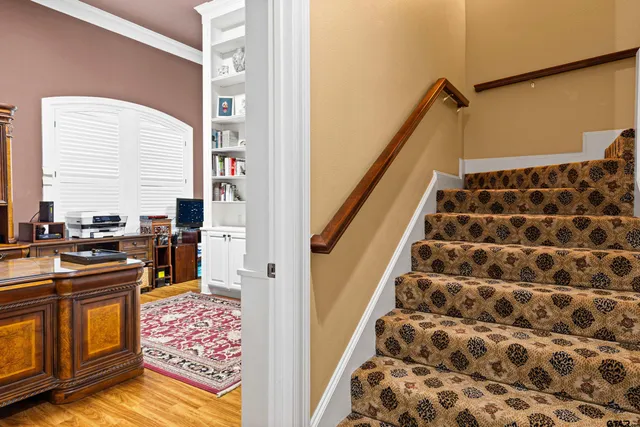 a view of walk in closet and wooden floor