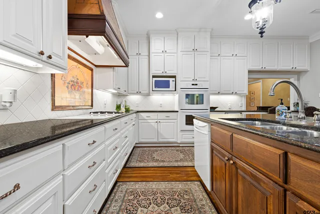 a kitchen with cabinets a sink and appliances