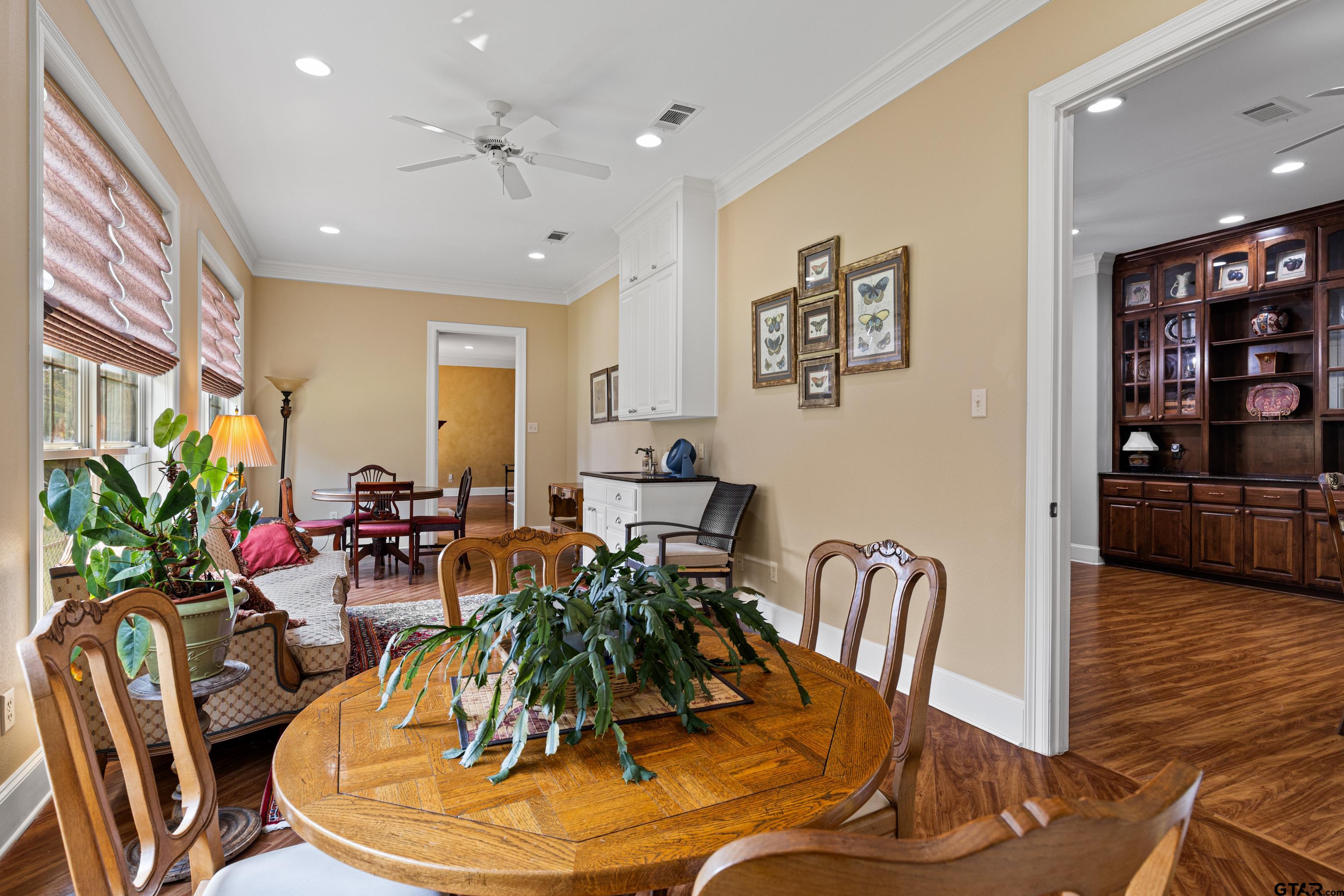 1360 East Main Street Henderson, TX 75652 - Photo 18 of 48 a dining room with furniture potted plants and wooden floor