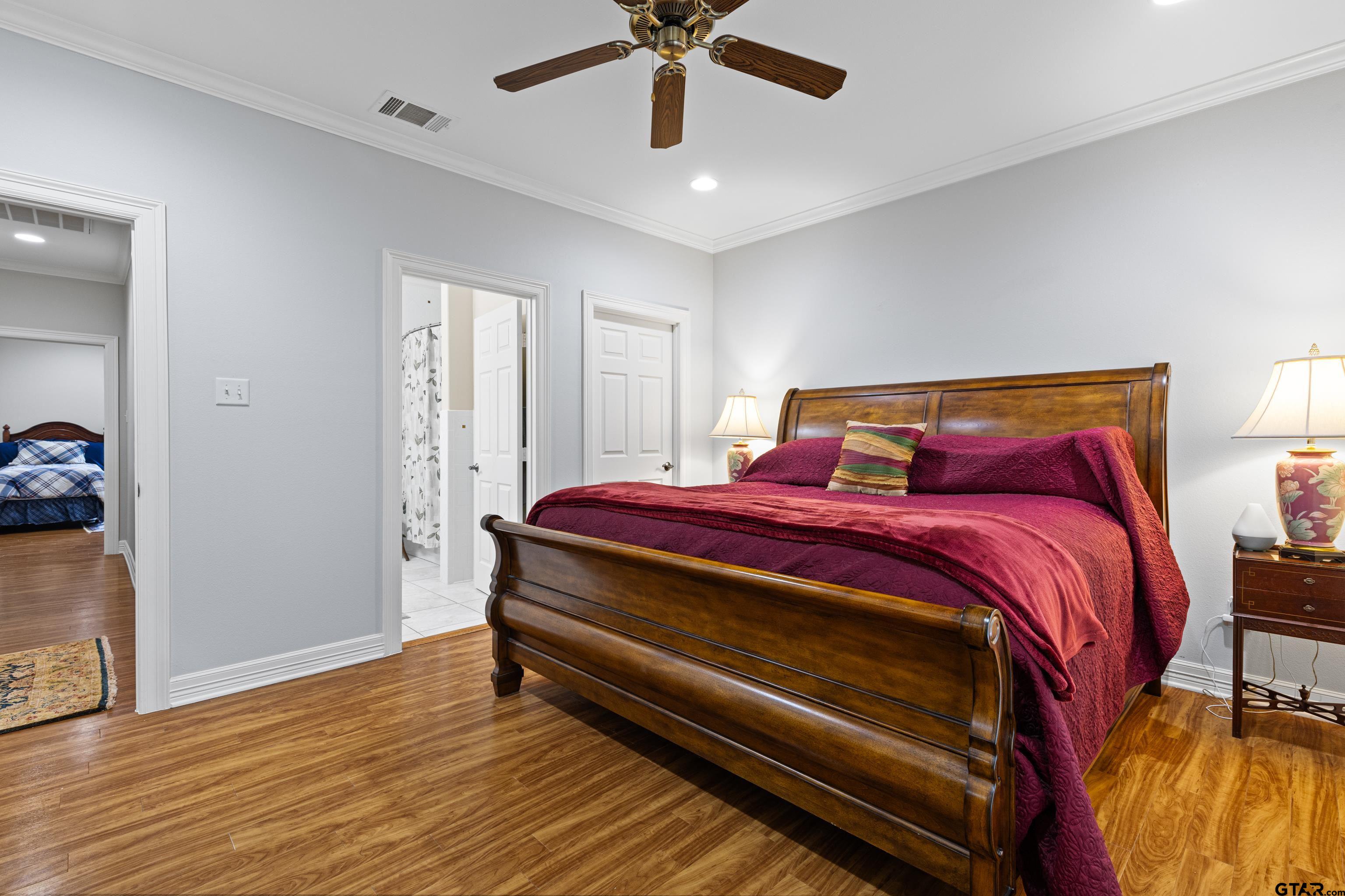 1360 East Main Street Henderson, TX 75652 - Photo 30 of 48 a bedroom with a bed and wooden floor