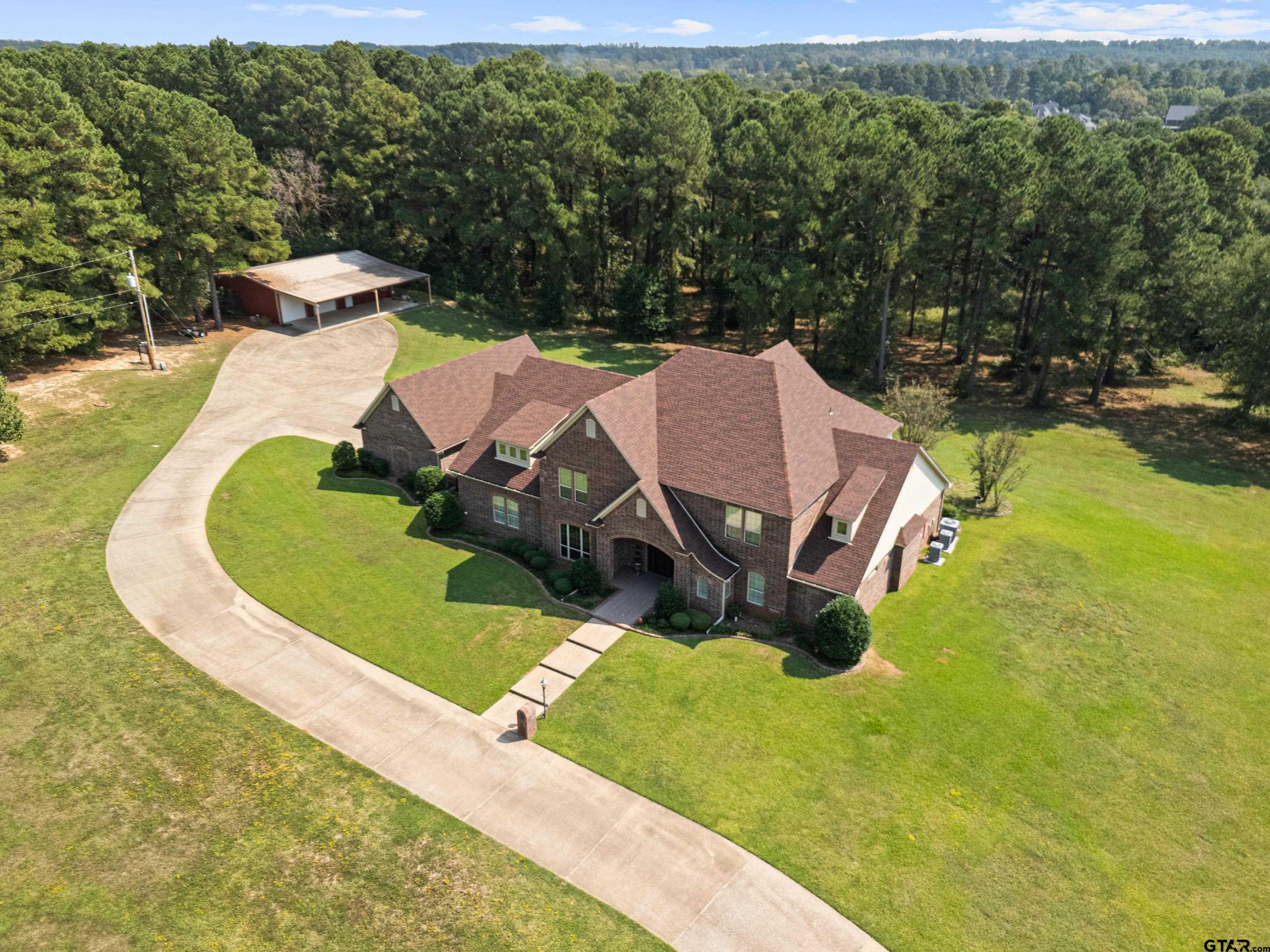 1360 East Main Street Henderson, TX 75652 - Photo 3 of 48 an aerial view of a house with a yard basket ball court and outdoor seating