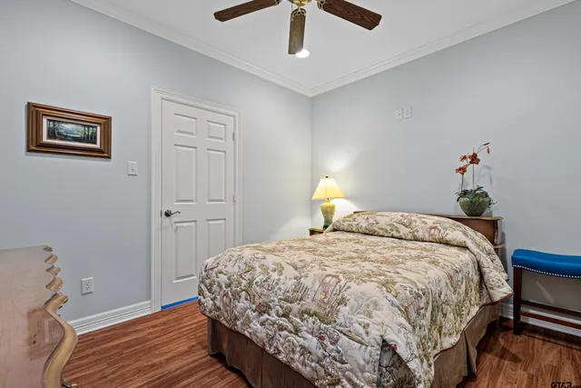 a bedroom with a bed a chandelier and a window