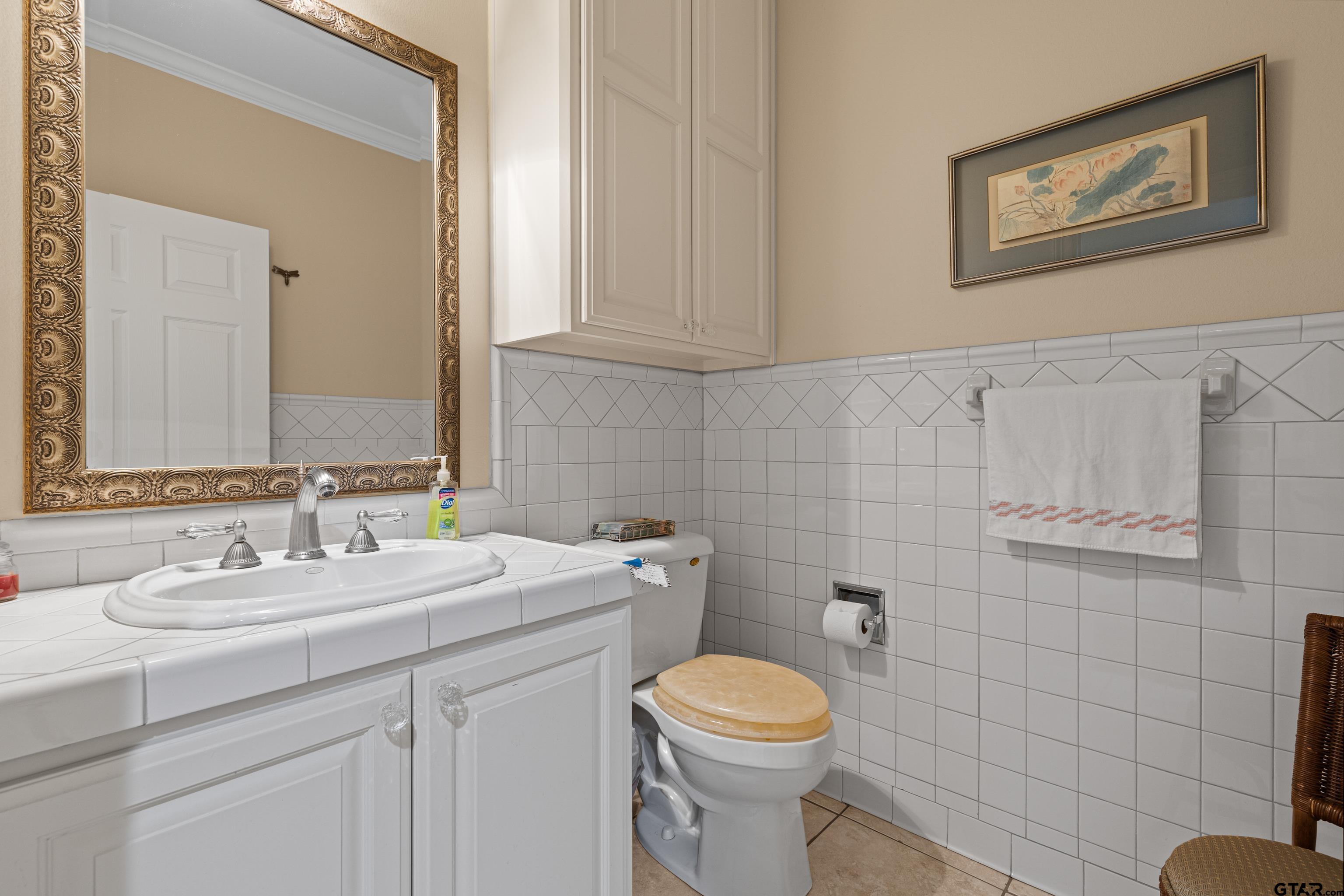 1360 East Main Street Henderson, TX 75652 - Photo 34 of 48 a bathroom with a toilet sink and mirror