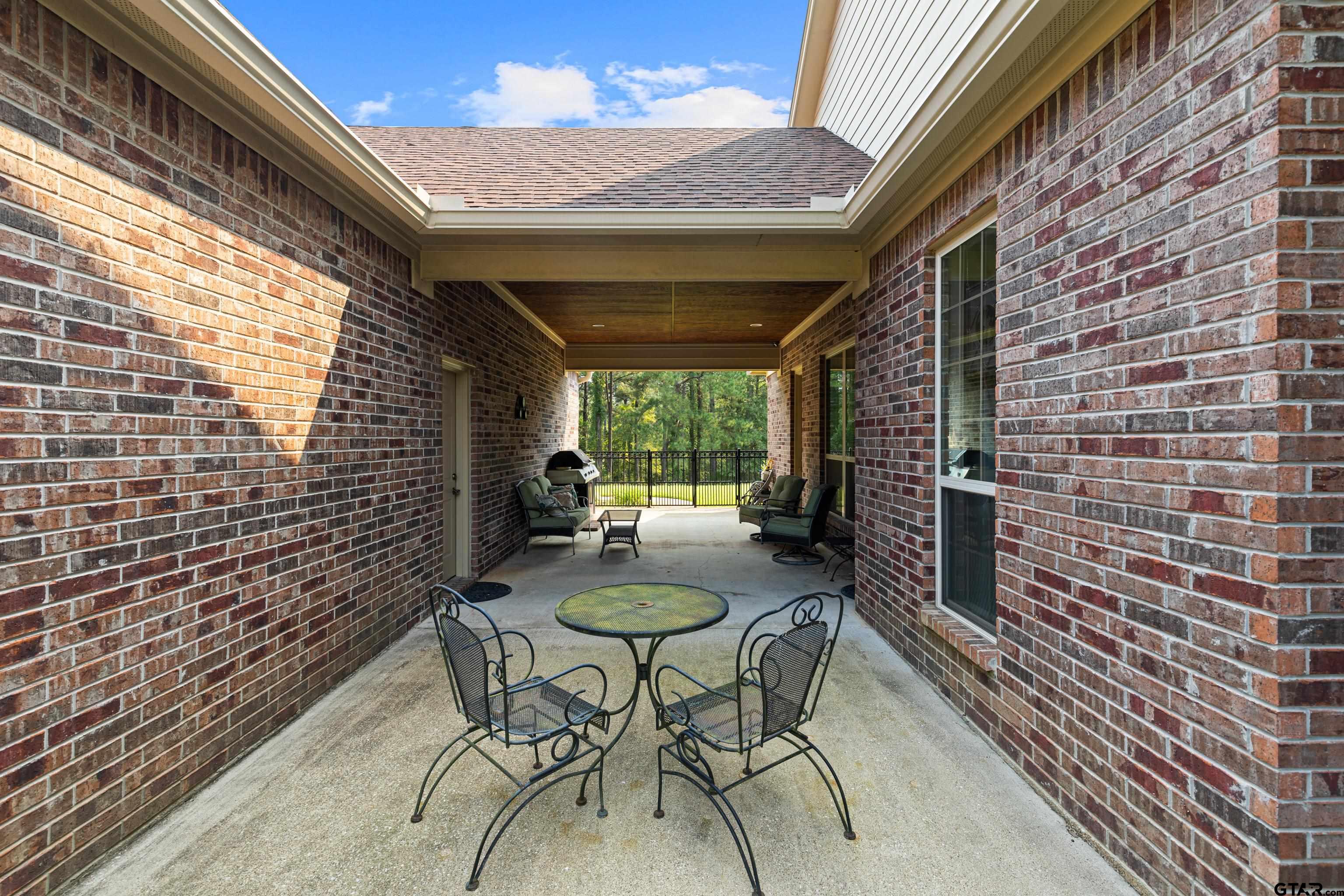 1360 East Main Street Henderson, TX 75652 - Photo 39 of 48 a view of a patio with table and chairs and potted plants