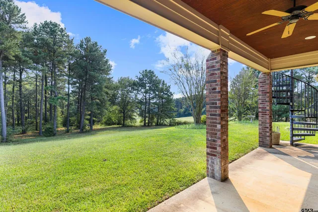 front view of a brick house with a yard