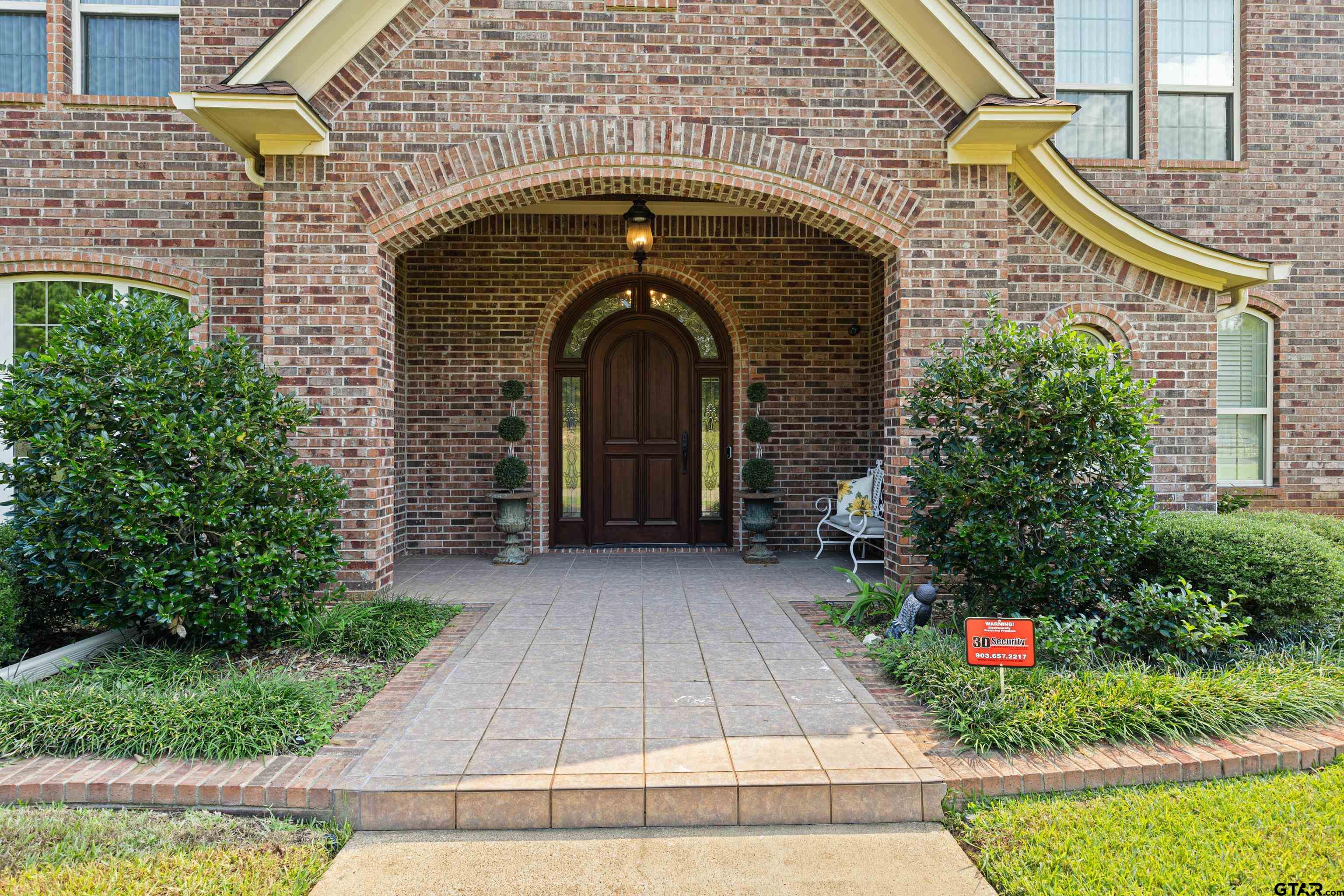 1360 East Main Street Henderson, TX 75652 - Photo 6 of 48 a front view of a house with an outdoor space