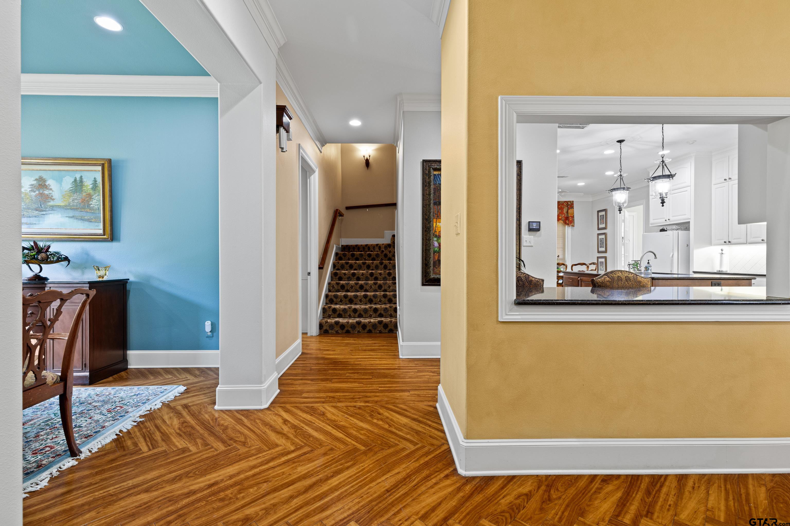 1360 East Main Street Henderson, TX 75652 - Photo 9 of 48 a view of a hallway with wooden floor and a living room