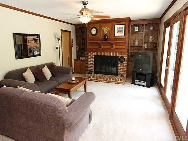 10033 Sycamore Road Raleigh, NC 27613 - Photo 5 of 12 17.0 x 14.0, Built In Bookcases, Masonry Fireplace, Crown Molding, French Doors Lead to Deck, Ceiling Fan with Light. Den/Family/Great Room