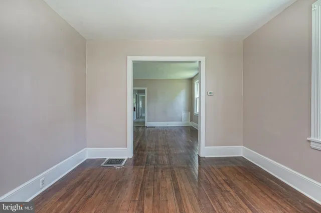 a view of a room with wooden floor and a sink