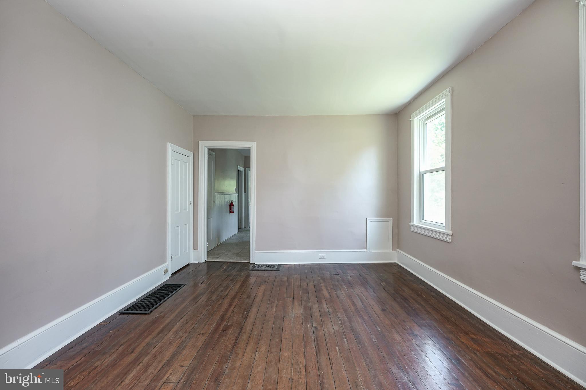 343 West 2nd Street Moorestown, NJ 08057 - Photo 7 of 31 a view of an empty room with wooden floor and a window