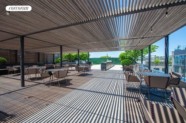 a view of a patio with dining table and chairs under an umbrella with a patio