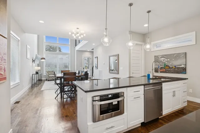a kitchen with stove a sink and chairs