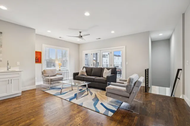 a living room with furniture and wooden floor