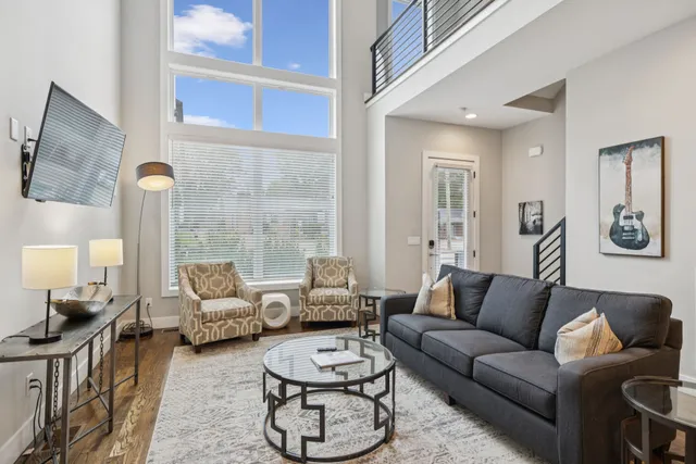 a living room with furniture or couch and a large window