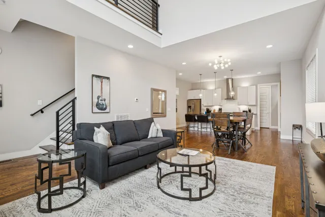 a living room with furniture and kitchen view