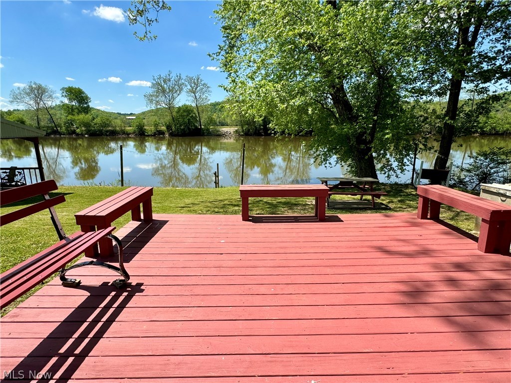 8551 South River Road Blue Rock, OH 43720 - Photo 24 of 43 View of dock featuring a deck with water view and a lawn