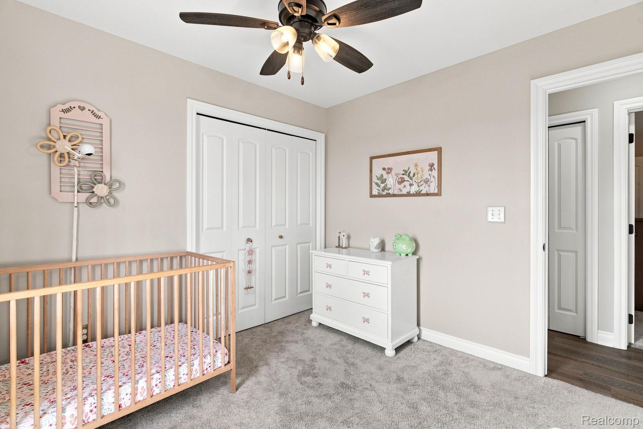629 Range Road Smiths Creek, MI 48074 - Photo 25 of 36 Neutral paint palette, ceiling fan with integrated lighting, white bi-fold closet doors, white trim, and light gray carpet