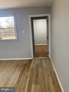 223 Kinsley Road Pemberton, NJ 08068 - Photo 8 of 12 an empty room with wooden floor and a window