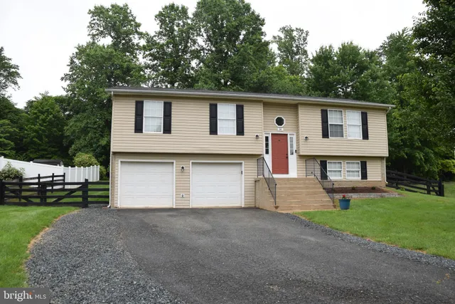 a front view of house with yard and trees