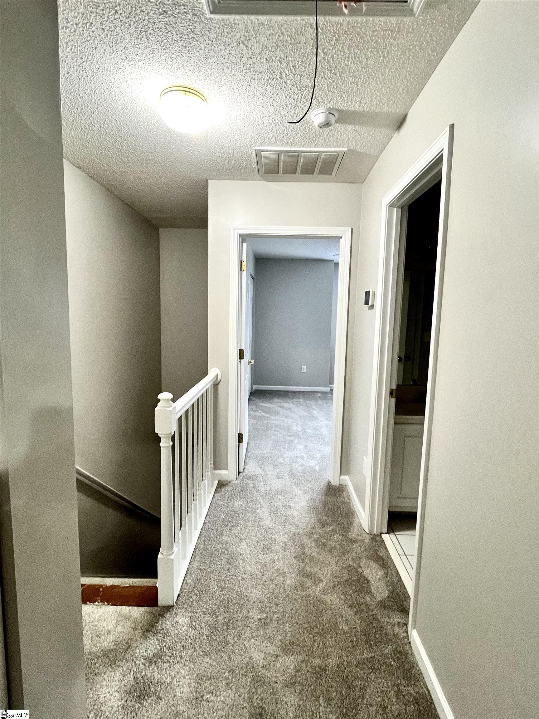 419 East Butler Road, Unit 7 Mauldin, SC 29662 - Photo 9 of 15 Stairway and upstairs hallway.