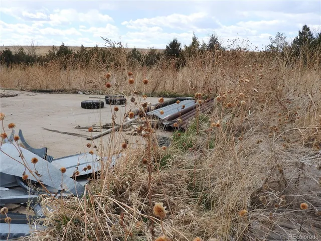 a view of a balcony with chair and wooden floor
