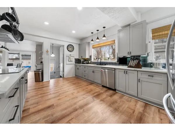 a kitchen with stainless steel appliances granite countertop a sink and cabinets