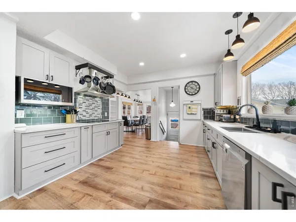 a large white kitchen with cabinets