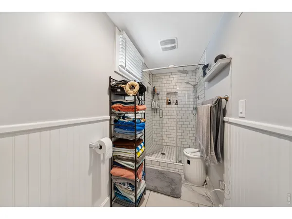 a bathroom with a shower toilet and a sink