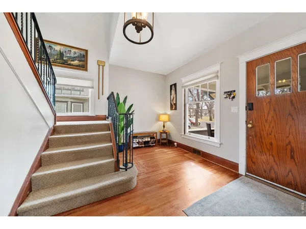 a view of an entryway with wooden floor
