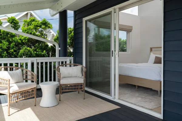 a balcony with furniture and potted plants