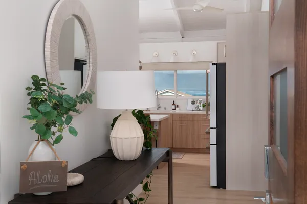 a room with a potted plant on the counter and cabinets