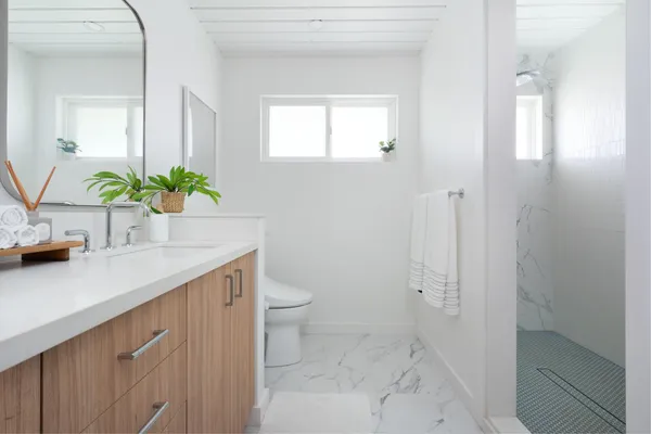 a bathroom with a sink a toilet and a mirror