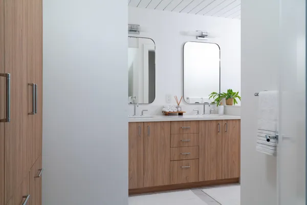 a bathroom with a double vanity sink and a mirror