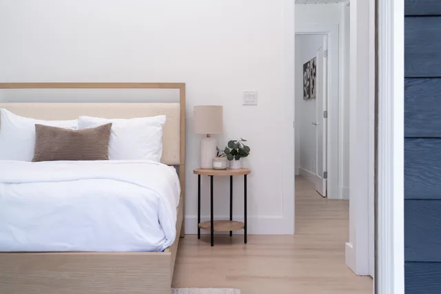 a bedroom with a bed and a table