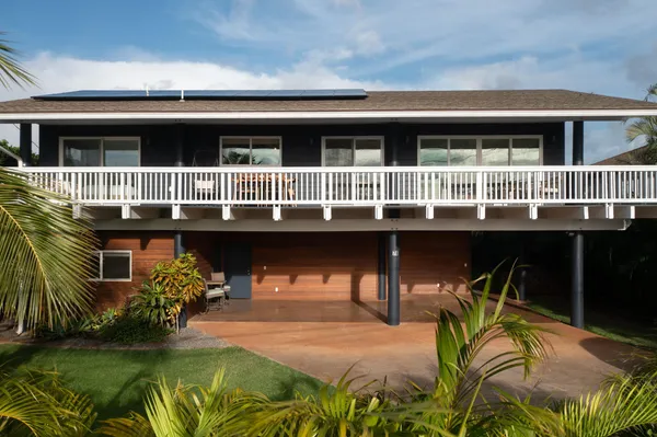 a view of a house with pool and sitting area