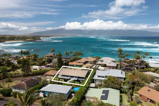 an aerial view of a house with a lake view