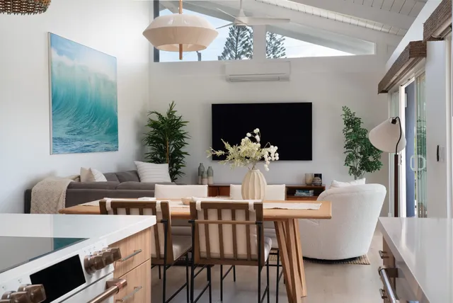 a dining room with furniture a chandelier and window