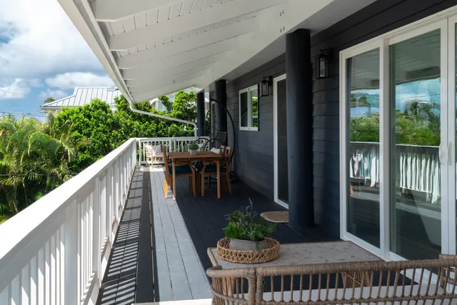 a balcony with table and chairs