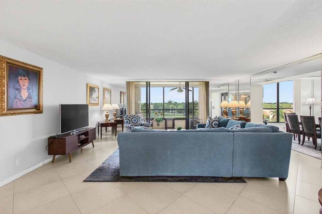 7145 Promenade Drive, Unit 602 Boca Raton, FL 33433 - Photo 13 of 90 a living room with furniture a flat screen tv and large window