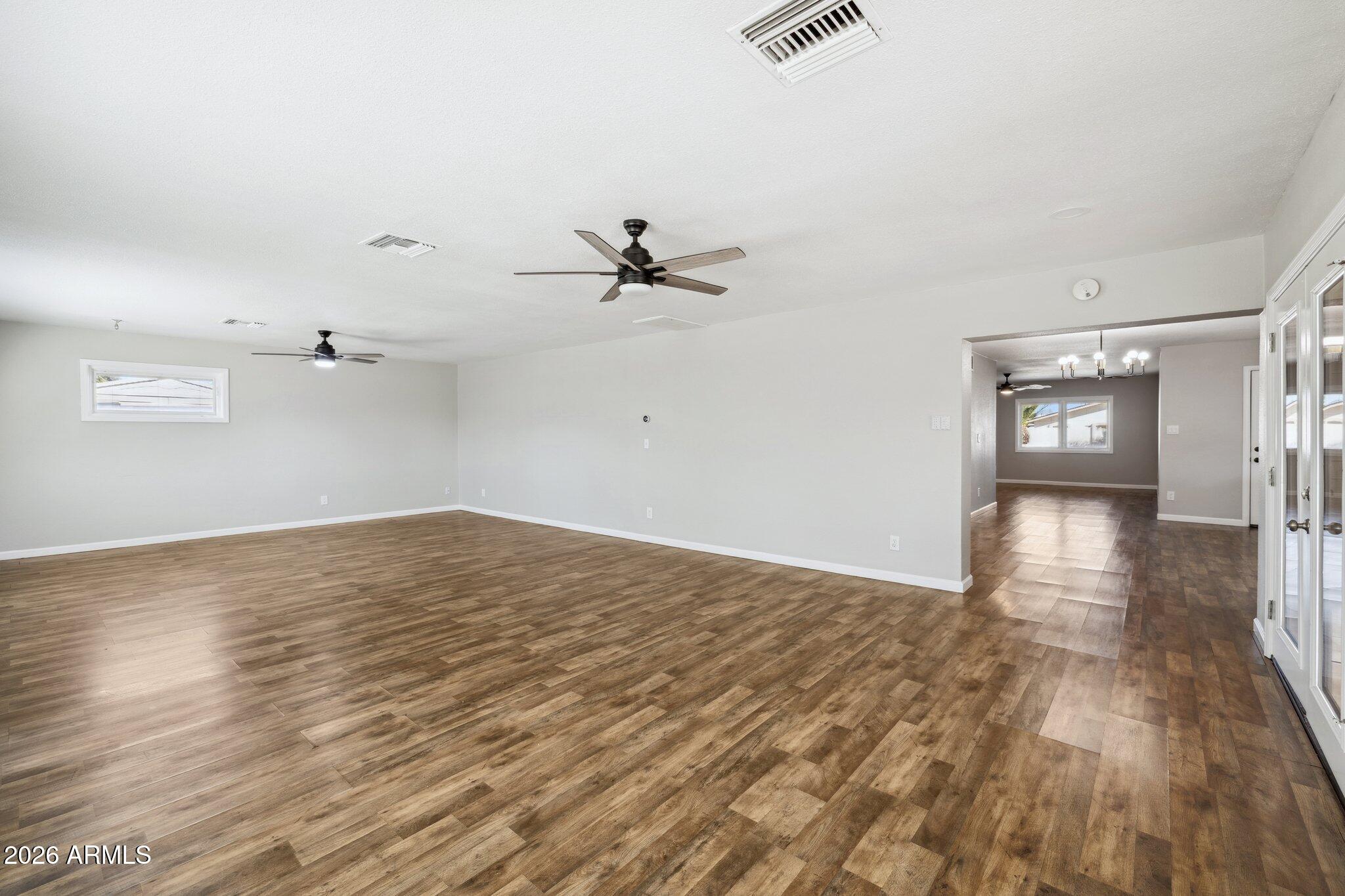 13002 North 28th Place Phoenix, AZ 85032 - Photo 16 of 42 an empty room with wooden floor and windows
