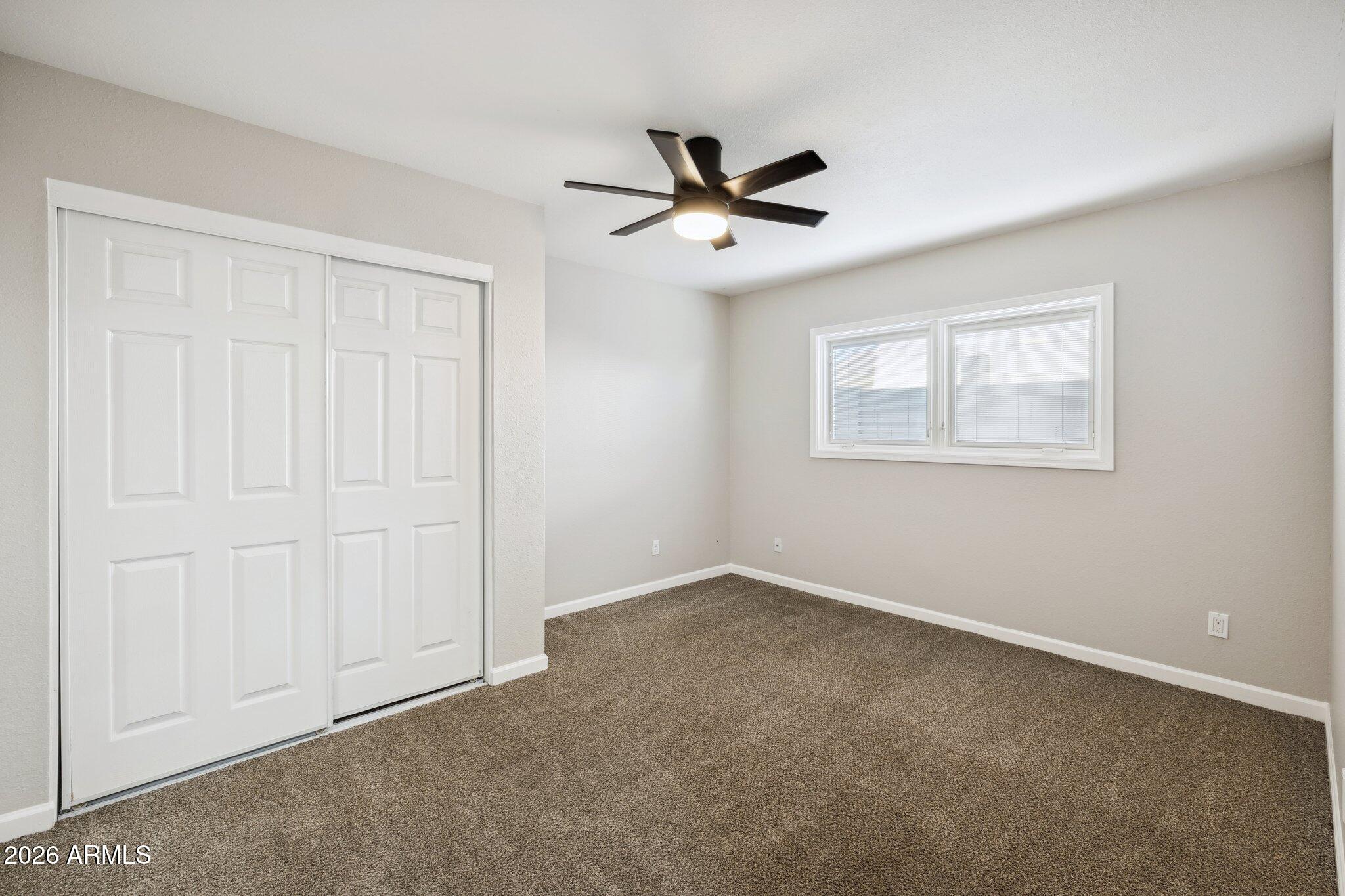 13002 North 28th Place Phoenix, AZ 85032 - Photo 19 of 42 a view of an empty room with a window